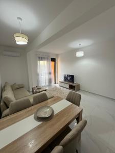 a living room with a table and a couch at FB Apartments in Ulcinj +4 photos