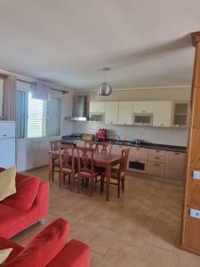 a kitchen and dining room with a table and chairs at Roan's apartament in Golem