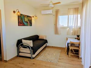 a living room with a couch and a table at צימר גבעוני in Keshet