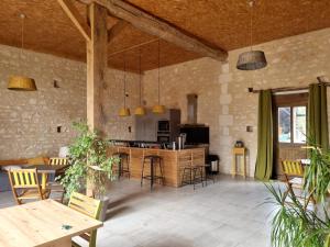 a kitchen and living room with tables and chairs at Chambres d'Hôtes du Paillé in Thenay