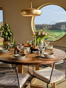 a dining table with chairs and a large mirror at Unique house in Nedstrand in Tysvær