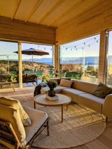 a living room with a couch and a table at Unique house in Nedstrand in Tysvær