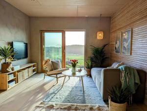 a living room with a couch and a table at Unique house in Nedstrand in Tysvær