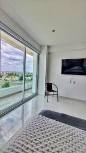 ein Schlafzimmer mit einem Bett und einem großen Fenster in der Unterkunft Puebla Vista Malinche in Lomas de Angelopolis