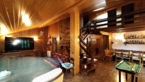 a living room with a swimming pool and a staircase at Appartamento Volturina in Fiumalbo