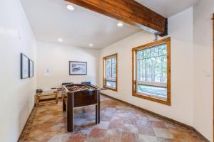 a living room with a table and a window at Whispering Pines in Whitefish