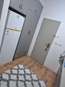 a room with two doors and a rug at ZEHAVI Guest House in Lahavot HaBashan