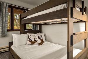 a bedroom with a bunk bed with two deer pillows at Cedar Creek Cabin in Whitefish +26 photos