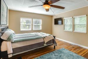 a bedroom with a bed and a ceiling fan at Lakefront Home with Hot Tub and Dock in Orlando! in Orlando +26 photos
