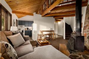 a living room with a couch and a fireplace at Cedar Creek Cabin in Whitefish