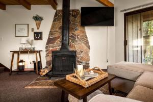a living room with a fireplace and a couch at Cedar Creek Cabin in Whitefish