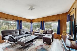 een woonkamer met een bank en een tv bij Courtney Cottage - Permit #3479 in Estes Park