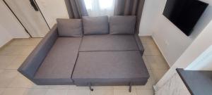a couch sitting in the corner of a room at Dolce Far Niente Greece in Agioi Theodoroi +18 photos