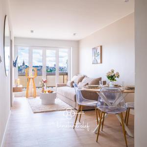 a living room with a couch and a table at Confort calme au Mans - Garage & ascenseur in Le Mans