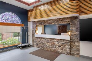 a room with a stone fireplace with a window at Best Western West Greenwich Inn in West Greenwich