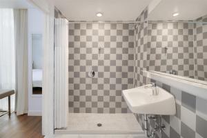 a bathroom with a sink and a shower at Best Western Premier Empire State Hotel in New York +45 photos