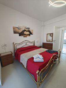 a bedroom with a large bed with a red blanket at Casa Vacanza Torino Stadio in Turin