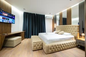 a bedroom with a bed and a flat screen tv at Hotel Tragjasi in Orikum +83 photos