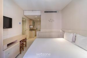 Resort pé na areia - Suítes JBVTOP客房内的一张或多张床位