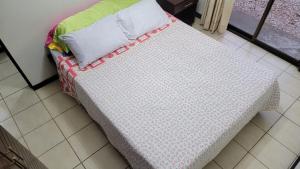 a bed with a pillow at Playas del Coco Cocomarindo 23 in Coco +14 photos