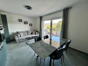 a living room with a table and a couch at Apartments Silenzio in Stari Grad