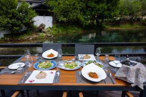 a wooden table with plates of food on it at Hotel Tragjasi in Orikum