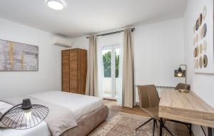 a bedroom with a bed and a desk and a table at Villa Stanzia Natura Crikvenica by Villas Guide in Bakarac +54 photos