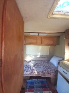 a small bedroom with a bed in an rv at Kamp kucice 