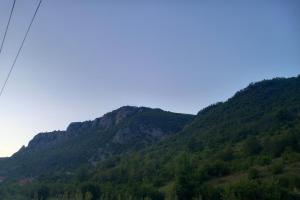 a mountain with green trees and a blue sky at Kamp kucice  +2 photos