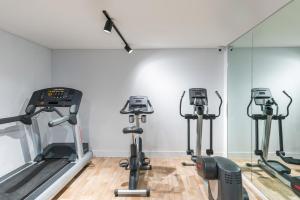 a gym with treadmills and elliptical machines at Kennigo Hotel Brisbane, Independent Collection by EVT in Brisbane