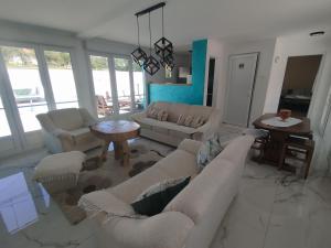 a living room with a couch and a table at Todorović SPA & bazen in Velereč