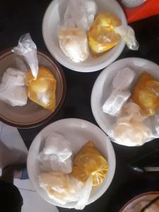 a group of four bowls filled with food in plastic bags at Rama Shinta Guesthouse & Coffee Yogyakarta in Yogyakarta