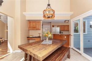 a kitchen with a wooden table with a vase of flowers at Bear Cabin-3 BR 2 Bath with Indoor Hot tub-one level-Pool Pass-Pet welcome in McGaheysville