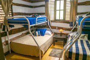a bedroom with two bunk beds in a cabin at 3BR Riverside Secret Retreat in Jarabacoa