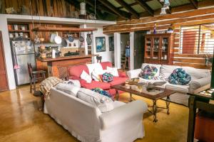 a living room with two couches and a table at 3BR Riverside Secret Retreat in Jarabacoa
