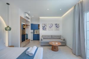 a living room with a couch and a table at Secret Garden Studios in Mytilene