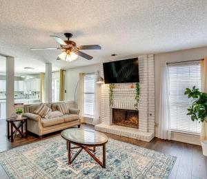 a living room with a couch and a fireplace at 5 BR House with heated pool near DFW and stadium in Grand Prairie