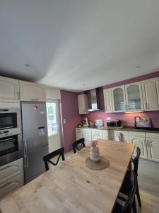 a kitchen with a wooden table with a cake on it at Escapade saint louis Basel in Saint-Louis