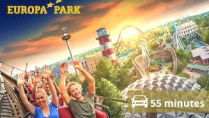 a group of people on a roller coaster at an amusement park at Escapade saint louis Basel in Saint-Louis