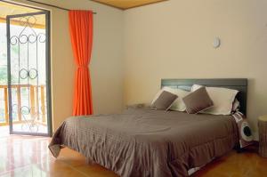 Postel nebo postele na pokoji v ubytování Hotel Campestre Rocas Del Paraíso