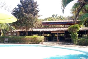 a resort with a swimming pool in front of a building at Recanto das Águas in Britânia