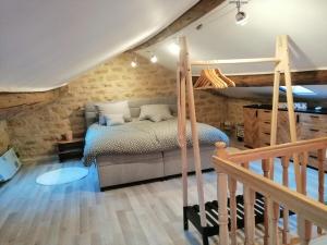 a bedroom with a bunk bed and a staircase at Logement à la campagne in Lamouilly