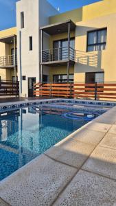 a house with a swimming pool in front of a building at MONACO Departamento PB in Federación