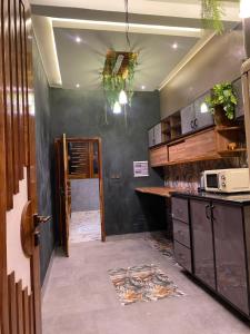 a kitchen with a counter and a microwave on the wall at Keur lumières in Dakar