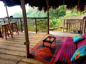 a porch with a couch and a table on a deck at Olimpos camping in Morogoro +39 photos