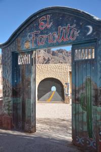 a building with a sign on it with a cactus at El Farolito Hostel in Tilcara