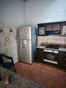 a kitchen with a stainless steel refrigerator and a stove at Casa Descanso in Tunía