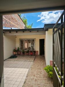 an external view of a house with a brick patio at Casa Descanso in Tunía