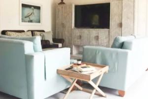 a living room with two couches and a coffee table at Holiday Time At Le Reve Beach House! in San Pedro