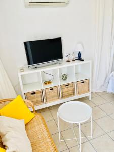 - un salon avec une télévision sur un meuble blanc dans l'établissement Villa Carla, à Oliva 26 autres photos
